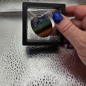 7 Chakra Worry Stone, an oval-shaped, polished gemstone designed for stress reli